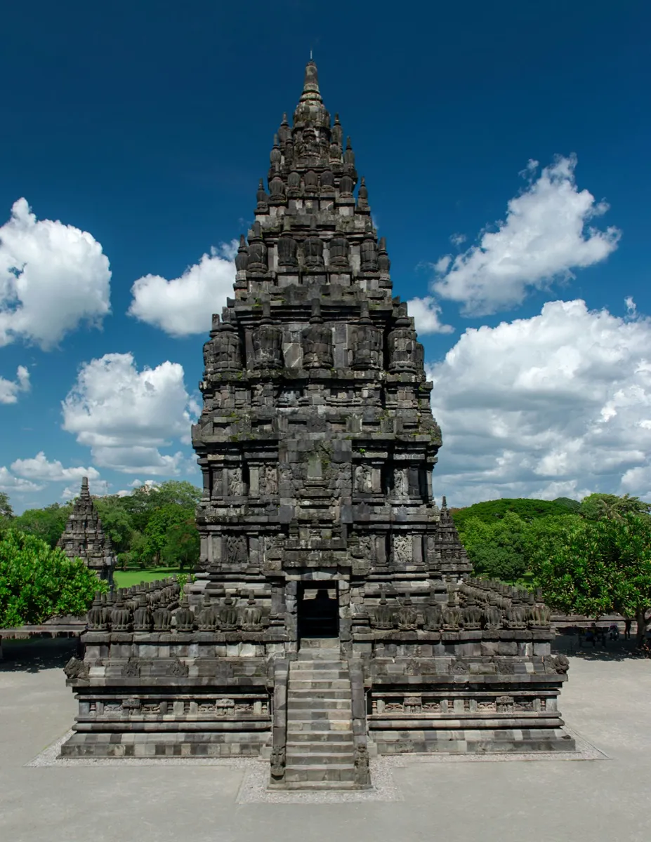 The towering silhouettes of Prambanan's main shrines emerge from the Javanese plain — a 45-minute Trans-Jogja bus ride or 30-minute taxi from Yogyakarta city centre