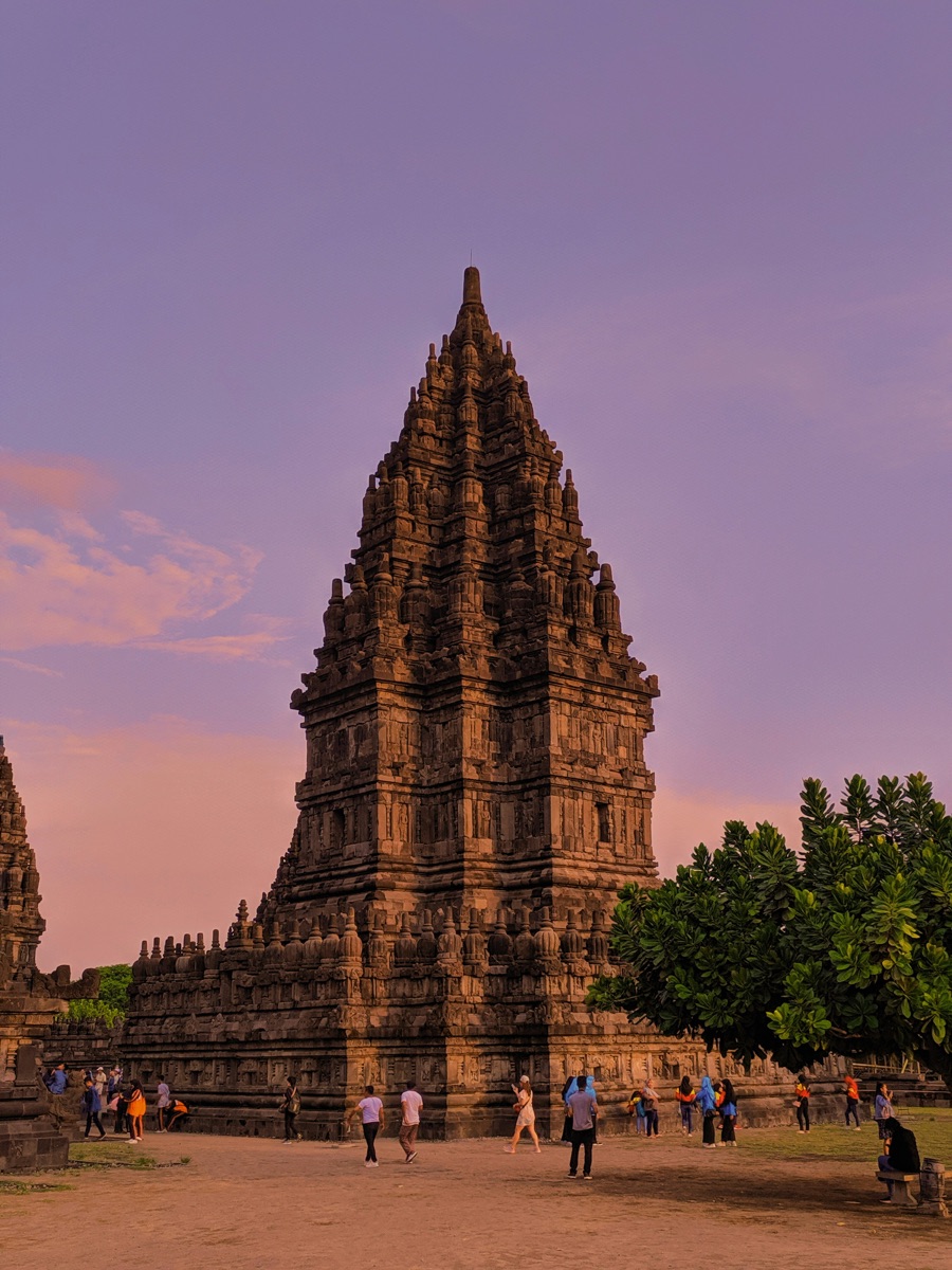 Prambanan Temple tower at sunset against a purple sky